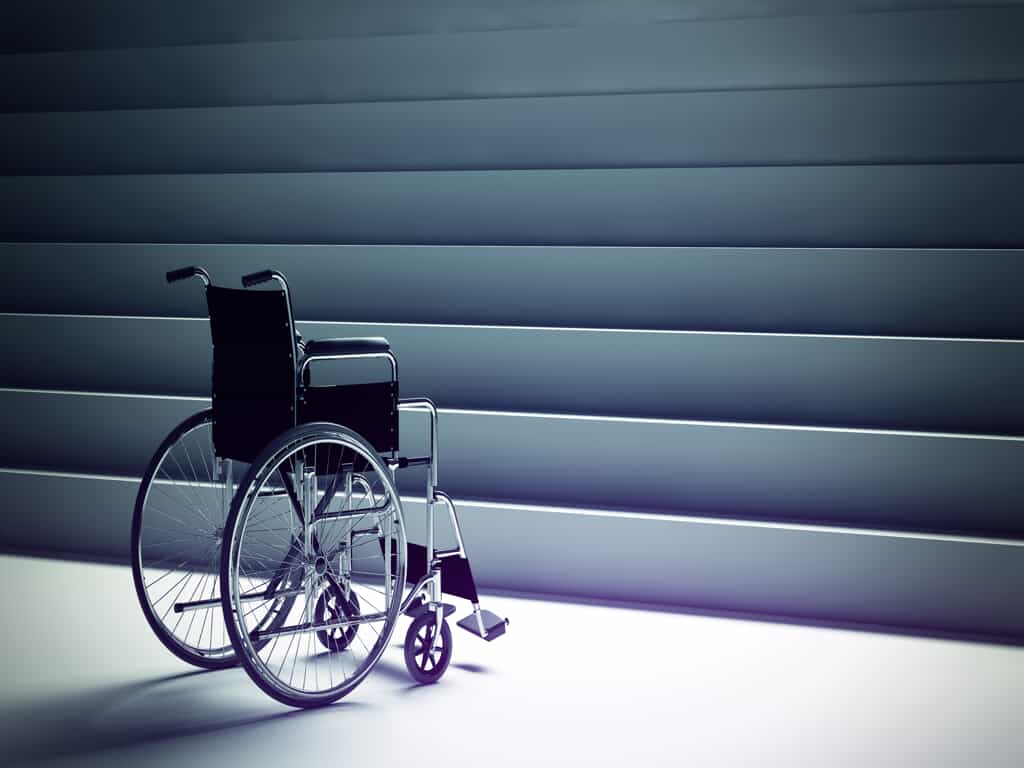 Empty Wheelchair in Front of a Staircase